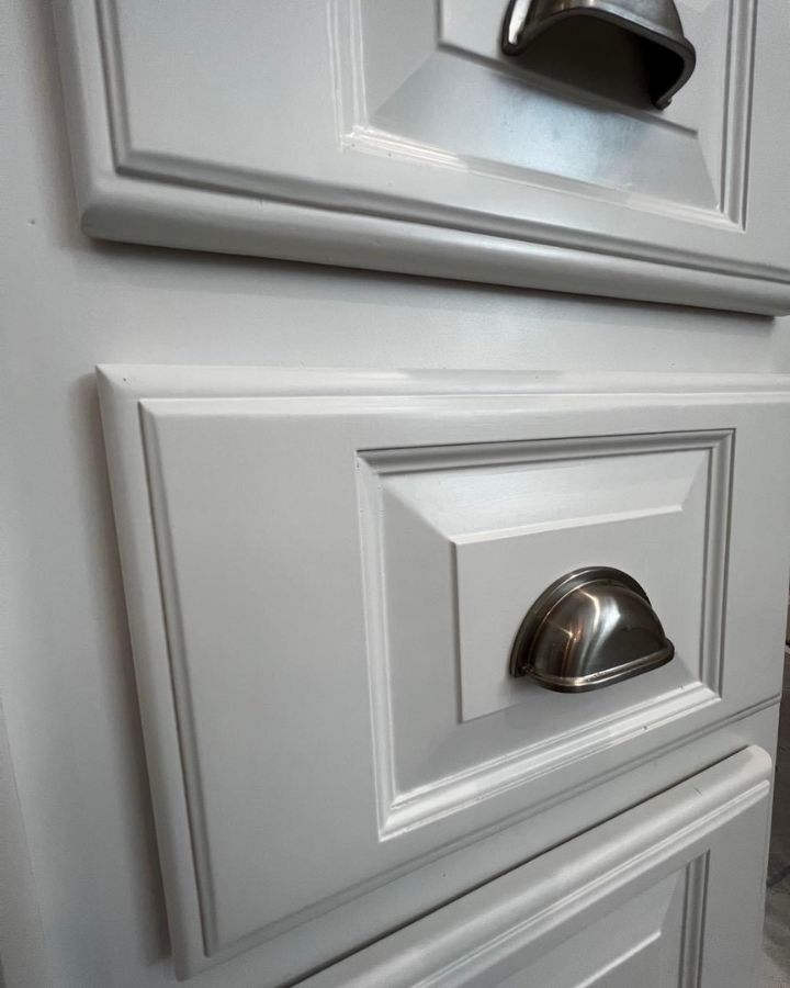 White painted cabinet with silver handles, refinished by Painters Pro KC.